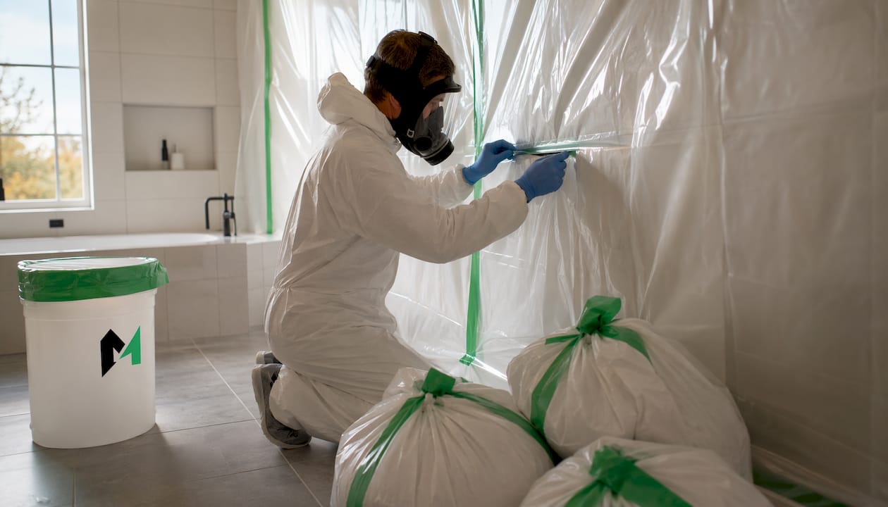 Contractor setting up asbestos containment area