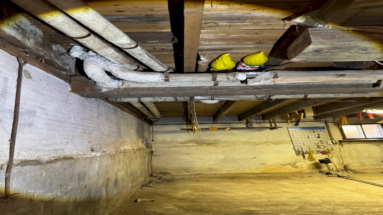 Photo of pipe insulation containing asbestos fiber in a mechanical ...