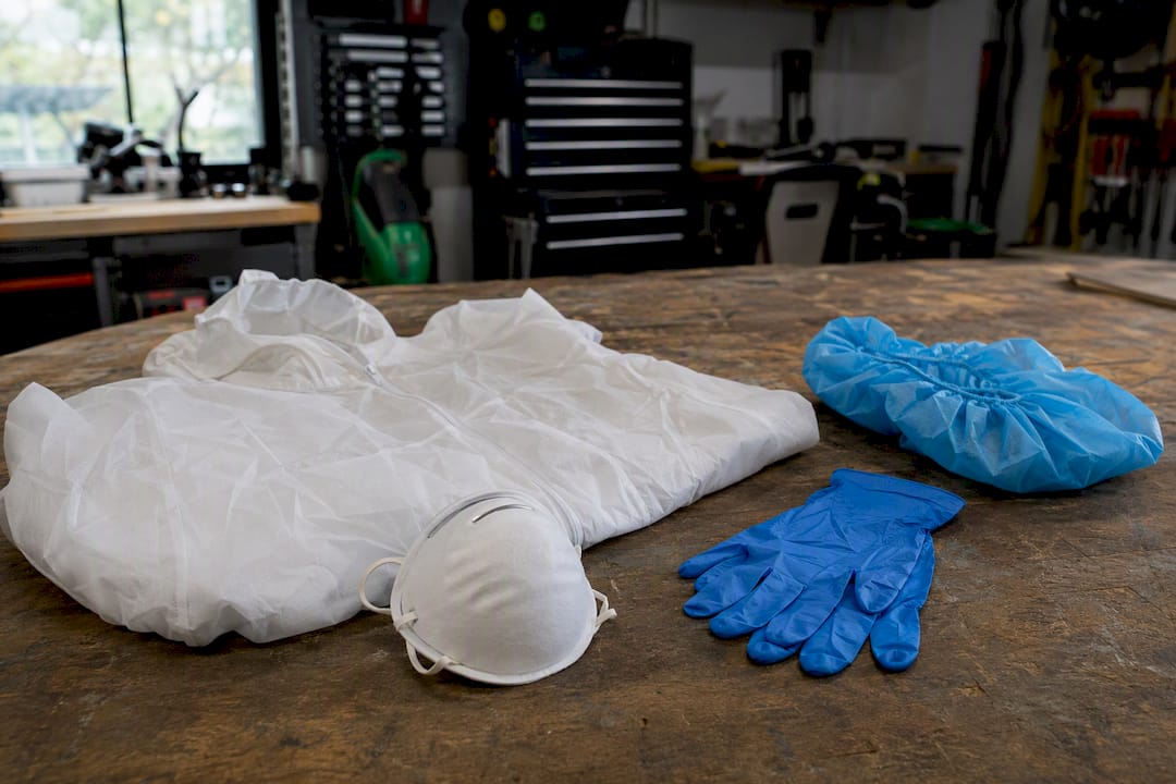 Asbestos protective gear arranged on plastic sheet