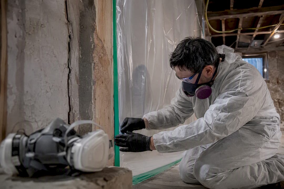 Technician sealing asbestos containment