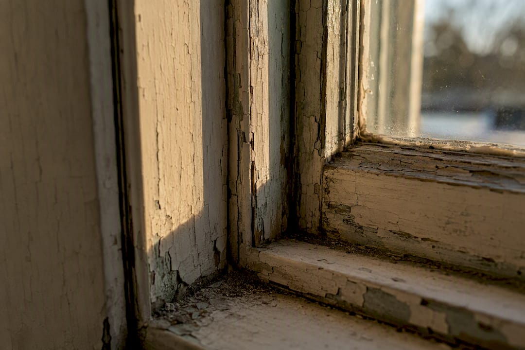Close-up of old window with peeling lead paint