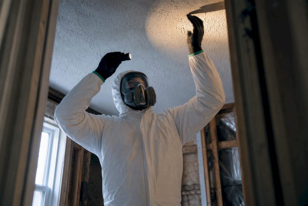 Technician inspecting suspect asbestos material