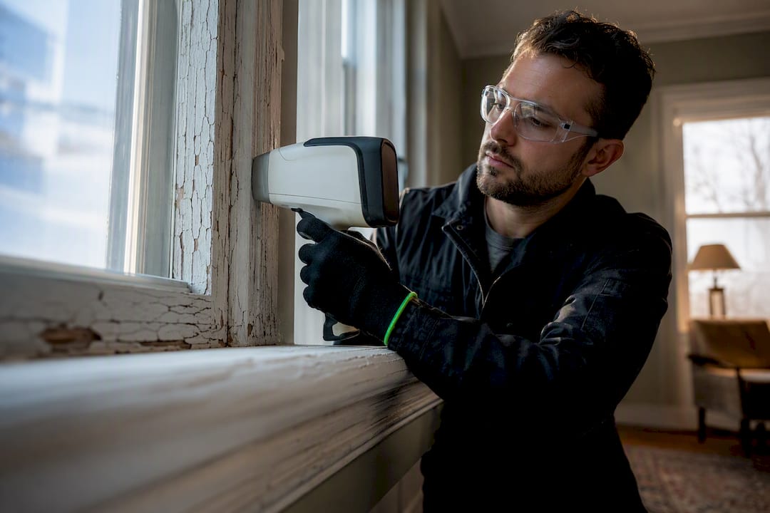 Technician testing painted window trim