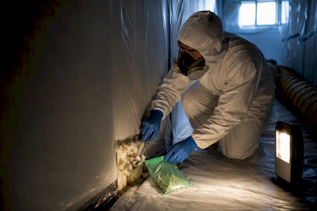 Technician collecting a controlled asbestos bulk sample